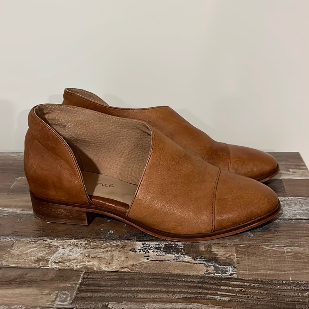 slightly worn leather loafers.